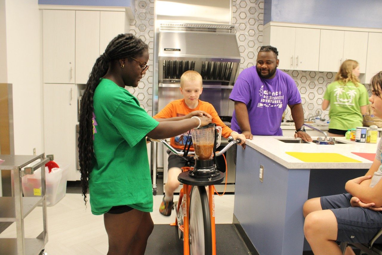 Salsa blending by youth with assistance from teen volunteer with supervision by 4-H adult